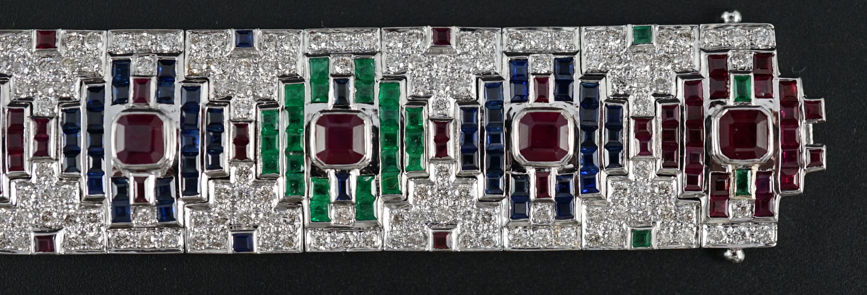 An attractive late 20th century 18k white gold, ruby, sapphire, emerald and diamond set bracelet